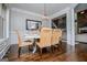 Bright dining area has a farmhouse table and stylish chairs, with a view into the living room at 125 High Bluff Trl, Carrollton, GA 30116