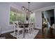 Dining room features a modern chandelier and view to outdoor scenery at 125 High Bluff Trl, Carrollton, GA 30116