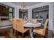 Well-lit dining room showcases woven chairs, a white table, and connections to adjacent living spaces at 125 High Bluff Trl, Carrollton, GA 30116