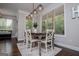 Dining room features a modern chandelier and view to outdoor scenery and living room at 125 High Bluff Trl, Carrollton, GA 30116