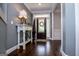 Inviting foyer features hardwood floors, a console table, and a dark wood front door with decorative wreath at 125 High Bluff Trl, Carrollton, GA 30116