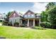 Beautiful two-story home with a welcoming front porch and well-maintained lawn, complemented by mature landscaping and serene surroundings at 125 High Bluff Trl, Carrollton, GA 30116