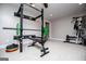 Bright home gym featuring a weight rack and various workout machines on a neutral carpet at 125 High Bluff Trl, Carrollton, GA 30116