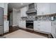 White kitchen featuring stainless steel appliances and unique backsplash tiles at 125 High Bluff Trl, Carrollton, GA 30116