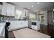 Kitchen with white cabinets, stainless steel appliances, and eat-in dining area at 125 High Bluff Trl, Carrollton, GA 30116