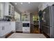 Kitchen with white cabinets, stainless steel appliances, and eat-in dining area at 125 High Bluff Trl, Carrollton, GA 30116