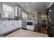 Kitchen with white cabinets, stainless steel appliances, and eat-in dining area at 125 High Bluff Trl, Carrollton, GA 30116