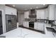 White kitchen features a large island with quartz counters and stainless steel appliances at 125 High Bluff Trl, Carrollton, GA 30116
