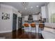 Bright kitchen features a large island with barstool seating, stainless steel appliances, and decorative backsplash at 125 High Bluff Trl, Carrollton, GA 30116