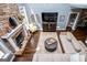 Inviting living room featuring a stone fireplace, hardwood floors, and comfortable seating area at 125 High Bluff Trl, Carrollton, GA 30116