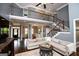 Spacious living room with a soaring ceiling, a staircase with metal railings, and views into the foyer at 125 High Bluff Trl, Carrollton, GA 30116