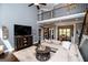 Bright living room with hardwood floors, fireplace, and large windows at 125 High Bluff Trl, Carrollton, GA 30116