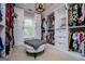 Spacious walk-in closet with custom built-in shelving and seating at 125 High Bluff Trl, Carrollton, GA 30116