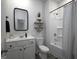 Bright bathroom featuring a shower-tub combo and a decorative mirror at 2108 Remy Ct, Kennesaw, GA 30144