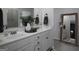Elegant bathroom featuring double vanity sinks, modern fixtures, and a large mirror with wood frame at 2108 Remy Ct, Kennesaw, GA 30144