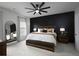 Comfortable bedroom with accent wall, ceiling fan, and ample natural light from the large windows at 2108 Remy Ct, Kennesaw, GA 30144
