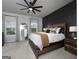 Stylish bedroom featuring a rustic wooden bed frame, large windows, and a modern ceiling fan at 2108 Remy Ct, Kennesaw, GA 30144