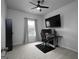 Comfortable bedroom with a dedicated computer desk, ceiling fan, and large window at 2108 Remy Ct, Kennesaw, GA 30144
