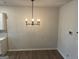 Dining room with chandelier lighting, light gray wood floors, and white walls at 2108 Remy Ct, Kennesaw, GA 30144