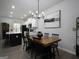 Open-concept dining and kitchen area with wood table, art, and a black island with counter seating at 2108 Remy Ct, Kennesaw, GA 30144