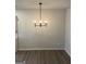 Dining room featuring modern chandelier, light gray walls, and wood floors at 2108 Remy Ct, Kennesaw, GA 30144
