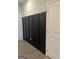 Stylish entryway featuring modern black wainscoting with gold-tone hooks and light wood grain flooring at 2108 Remy Ct, Kennesaw, GA 30144
