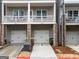 An inviting exterior view of townhomes with garages and shaded balconies at 2108 Remy Ct, Kennesaw, GA 30144