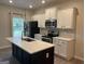 Modern kitchen with a large island, stainless steel appliances, and white cabinets at 2108 Remy Ct, Kennesaw, GA 30144