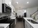 Elegant kitchen featuring a breakfast bar, modern appliances, and an open layout to dining area at 2108 Remy Ct, Kennesaw, GA 30144