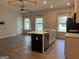 Open-concept kitchen with a large island, stainless steel appliances, and white shaker cabinets at 2108 Remy Ct, Kennesaw, GA 30144