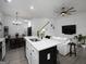 Stylish kitchen with an island and stainless appliances, flowing into the open-concept living space at 2108 Remy Ct, Kennesaw, GA 30144