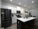 Modern kitchen with white cabinets, stainless steel appliances, and a large center island at 2108 Remy Ct, Kennesaw, GA 30144