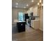 Modern kitchen with stainless steel appliances, white cabinets, and an island with quartz countertop at 2108 Remy Ct, Kennesaw, GA 30144
