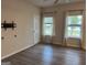 Inviting living room with light gray wood floors, white walls, and plenty of natural light at 2108 Remy Ct, Kennesaw, GA 30144
