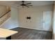 Living room with light gray wood floors, tv wall mount, staircase and white front door at 2108 Remy Ct, Kennesaw, GA 30144