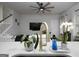 Bright, open-concept living space featuring a modern kitchen island, and a staircase with white railing at 2108 Remy Ct, Kennesaw, GA 30144