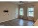 Inviting living room with light gray wood floors, white walls, and plenty of natural light at 2108 Remy Ct, Kennesaw, GA 30144