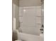 Clean white bathroom bathtub and shower featuring convenient shelving at 620 Sedona Loop, Hampton, GA 30228
