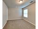Bedroom featuring carpet flooring, a window, and a closet door at 620 Sedona Loop, Hampton, GA 30228