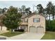 Charming two-story brick home with attached two car garage and manicured lawn at 620 Sedona Loop, Hampton, GA 30228