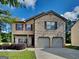 Charming two-story home featuring a brick facade and a two-car garage at 620 Sedona Loop, Hampton, GA 30228