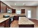 Modern kitchen with granite countertops, stainless steel appliances, and central island at 620 Sedona Loop, Hampton, GA 30228
