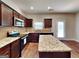 Well-equipped kitchen with granite counters, an island, and stainless steel appliances at 620 Sedona Loop, Hampton, GA 30228