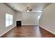 This large living room features a fireplace, ceiling fan, and large windows at 620 Sedona Loop, Hampton, GA 30228