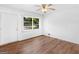 Well-lit bedroom with wood floors, a ceiling fan, and a large window with backyard view at 840 Jett Rd, Jonesboro, GA 30236