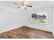 Bright bedroom featuring vinyl floors, a ceiling fan, and a door with a window view at 840 Jett Rd, Jonesboro, GA 30236