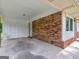 This carport features a brick accent wall and a white ceiling at 840 Jett Rd, Jonesboro, GA 30236