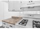 Updated kitchen with white cabinets, stone countertops, and modern appliances, including a gas stove at 840 Jett Rd, Jonesboro, GA 30236