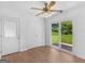 Living room with light wood floors, ceiling fan, and glass sliding doors to backyard deck at 840 Jett Rd, Jonesboro, GA 30236
