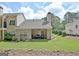 Expansive backyard showcasing a covered patio, lush lawn, and landscaping, ideal for outdoor living at 1801 Ridgefield Dr, Peachtree City, GA 30269